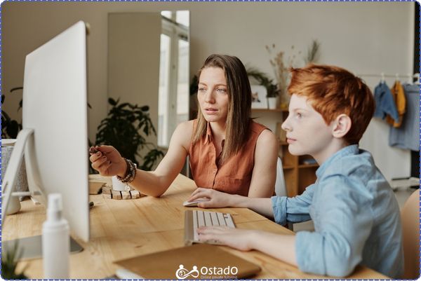 A tutor and a student looking at a screen