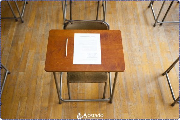 A chair, a desk and an exam paper on it