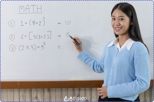 A photo of a girl teaching maths on a whiteboard